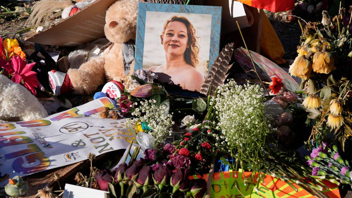 Flowers and photos are left at a memorial site for Renee Good on Jan. 31, in Minneapolis. Her family sued the federal government and immigration officials over her killing on Thursday.