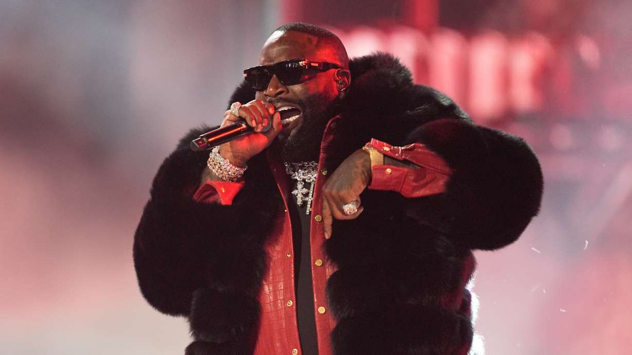 Rick Ross performs during the BET Awards in Los Angeles on June 28. Ross was arrested early Thursday in Miami Beach and charged with battery related to a domestic violence accusation, authorities said.