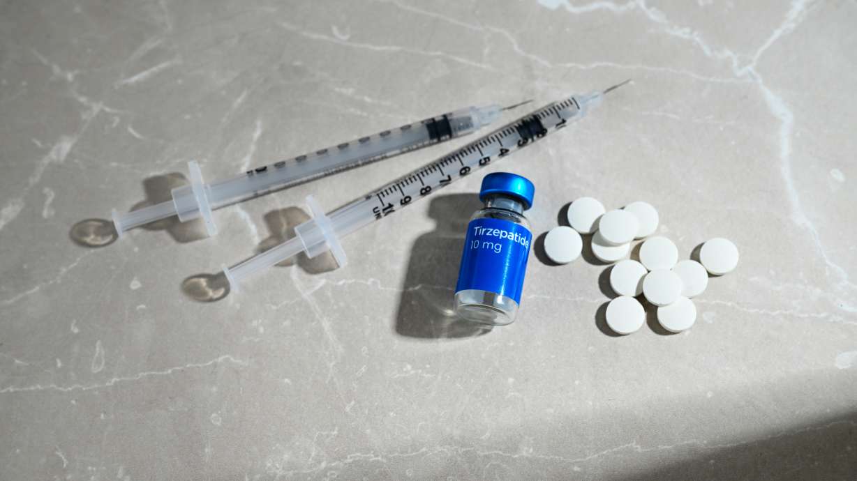 Glass Vial with Tirzepatide Compound and Single Use Syringes Next to GLP-1 Weight Loss Pills