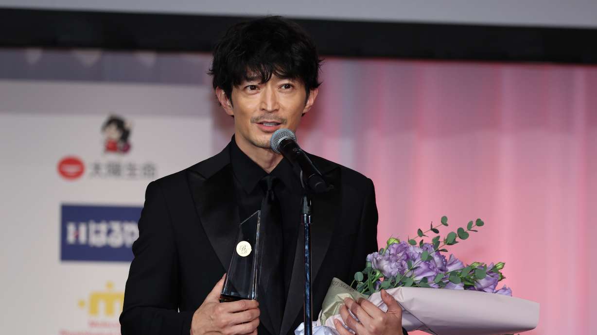 Japanese voice actor Kenjiro Tsuda receives the best dresser award in the entertainment category during an award ceremony in Shibuya, Tokyo on Nov. 27, 2024. A Tokyo court has awarded legal protection for the human voice in a landmark case involving Tsuda.