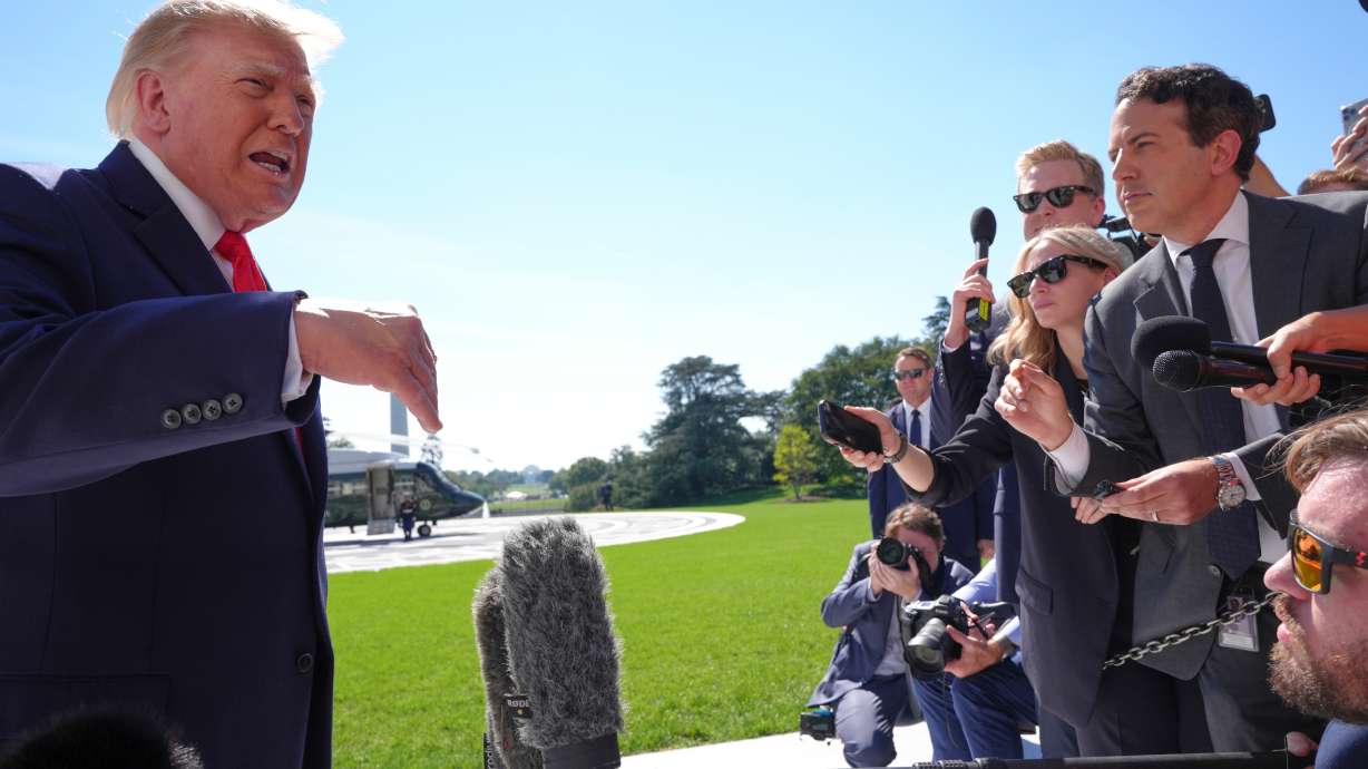 President Donald Trump speaks with reporters before boarding Marine One on the South Lawn of the White House on Thursday in Washington.