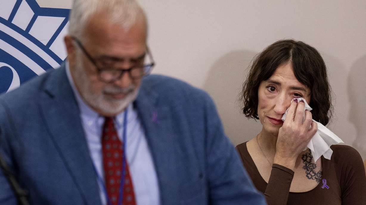 Shae Thomson wipes away a tear as Salt Lake County District Attorney Sim Gilli speaks of another woman’s ordeal with an abusive husband at the Salt Lake County District Attorney’s Building on Thursday.
