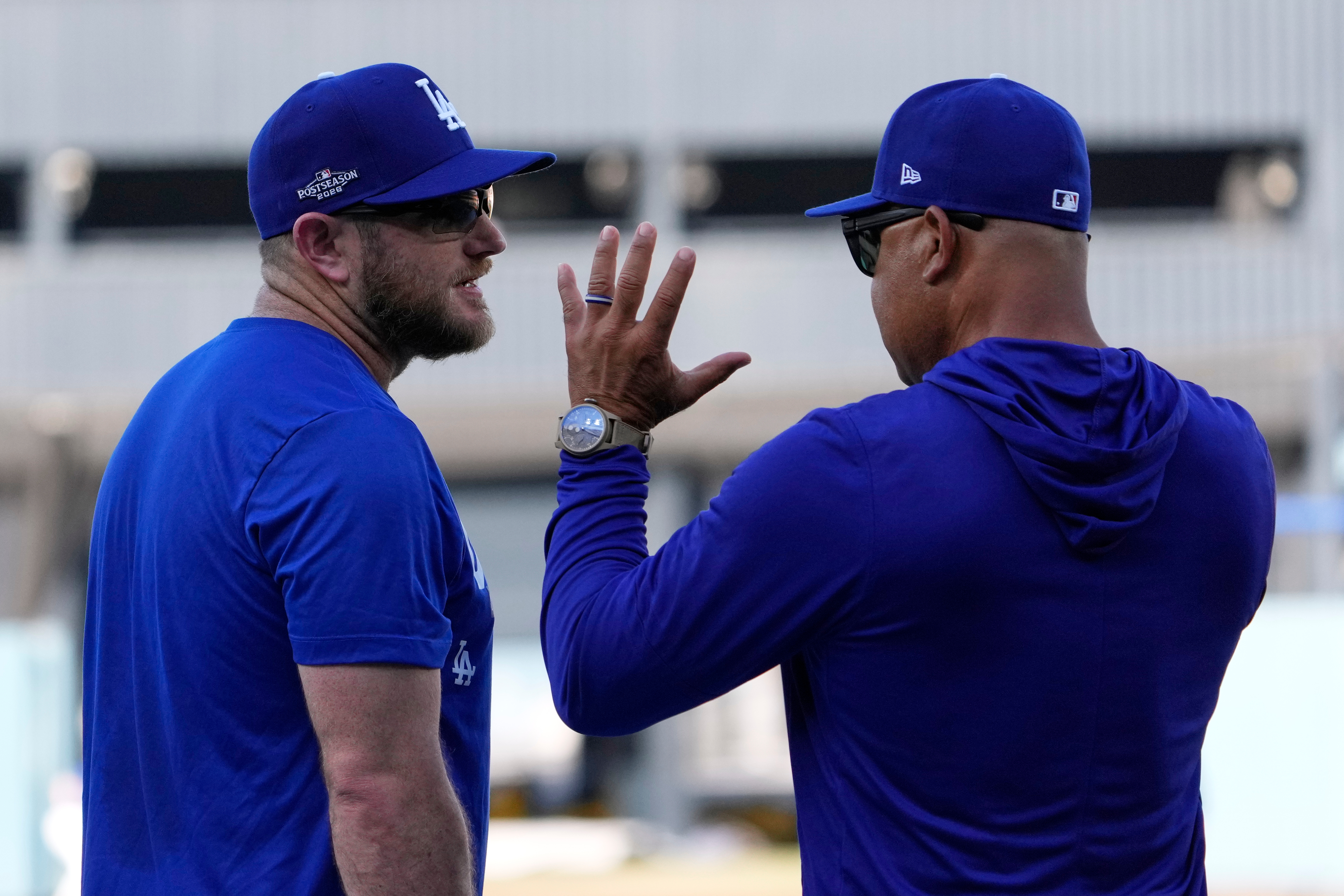 Los Angeles Dodgers third baseman Max Muncy, left, talks with manager Dave Roberts during practice ahead of a baseball NL Division Series Thursday, Oct. 1, 2026, in Los Angeles. 