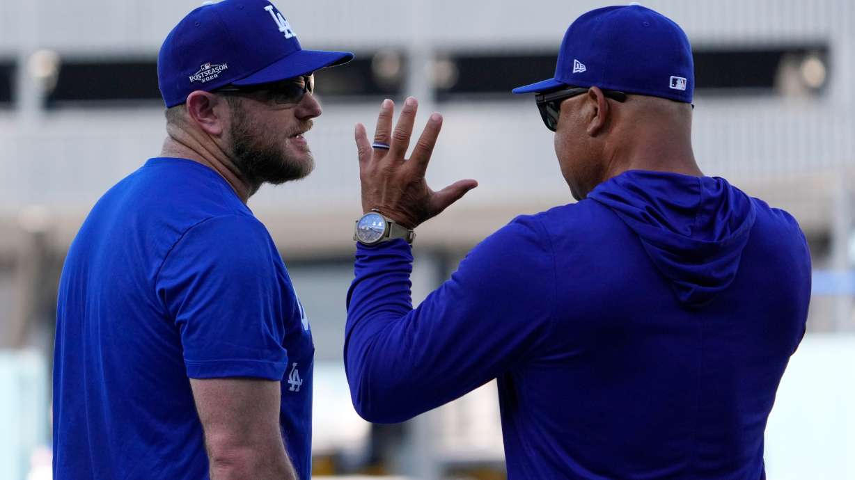 Los Angeles Dodgers third baseman Max Muncy, left, talks with manager Dave Roberts during practice ahead of a baseball NL Division Series Thursday, Oct. 1, 2026, in Los Angeles.