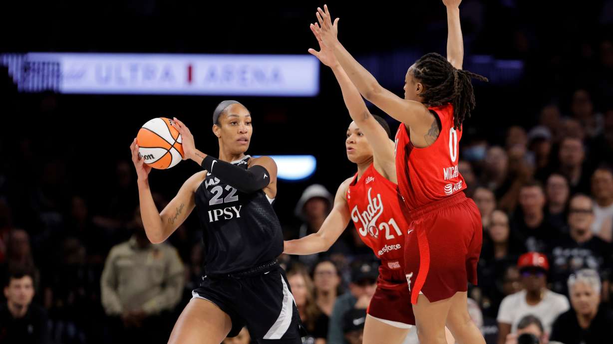 Las Vegas Aces center A'ja Wilson (22) is pressured by Indiana Fever forward Makayla Timpson (21) and guard Kelsey Mitchell (0) during the first half in Game 3 of an WNBA basketball first-round playoff series Thursday, Oct.1, 2026, in Las Vegas.