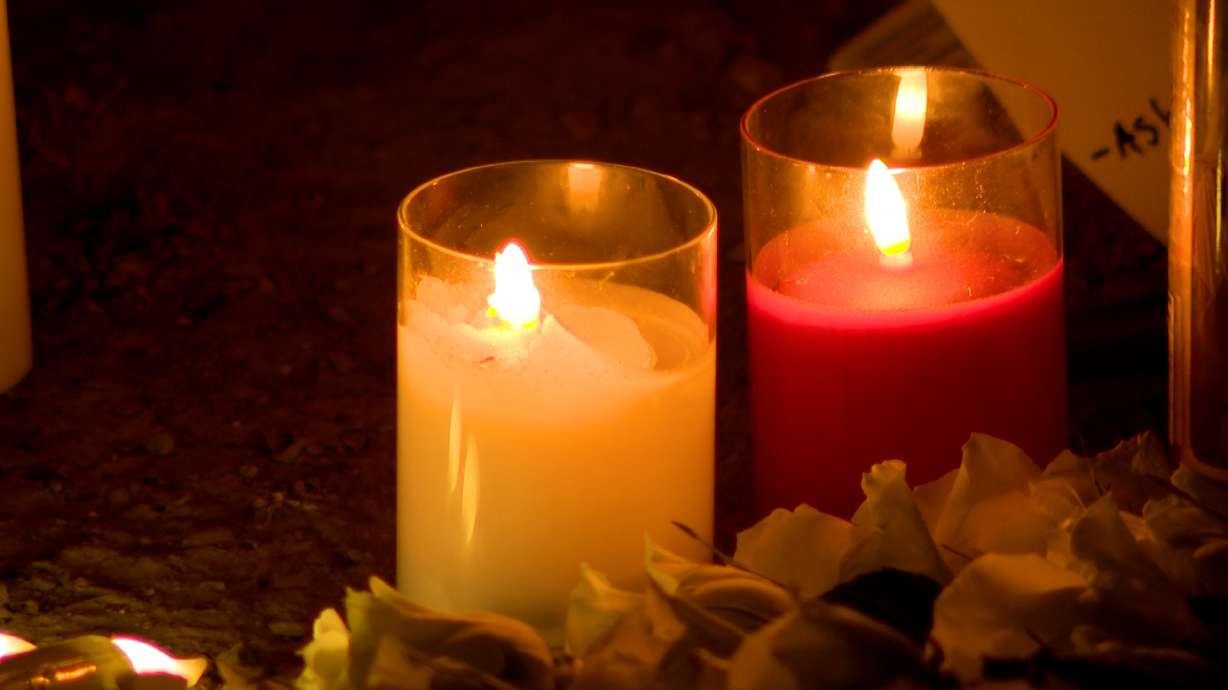 Community members held a vigil Thursday night for members of a Riverdale family who died in a house fire.