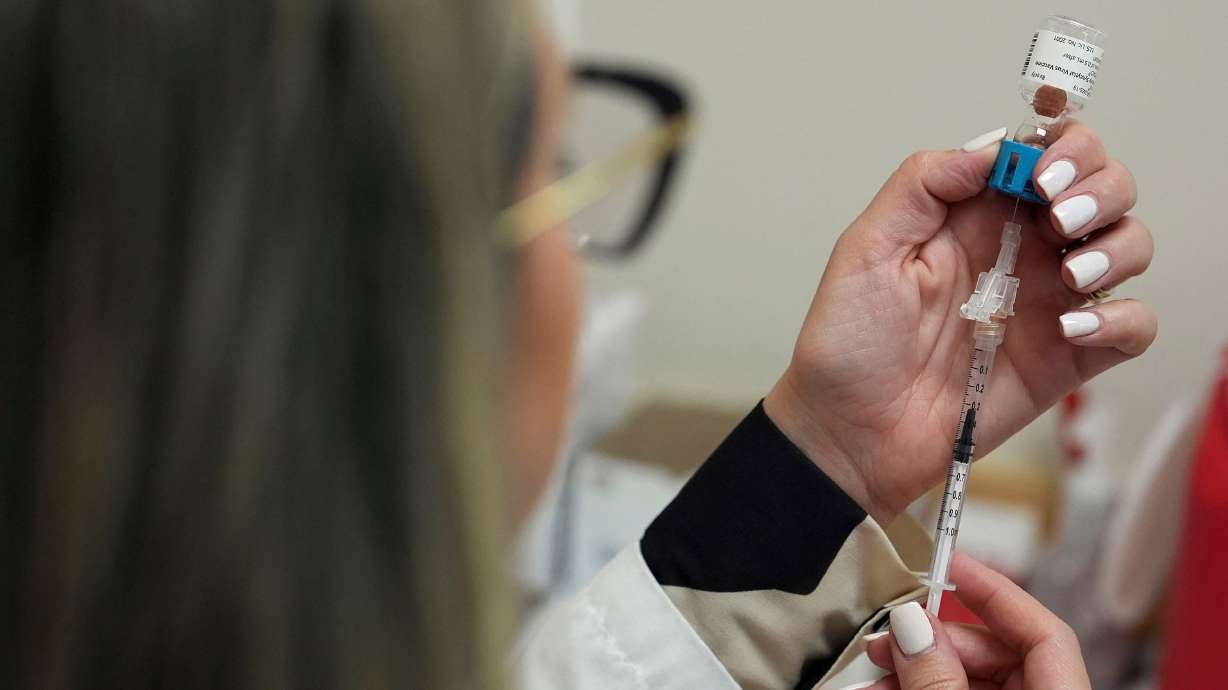 Pharmacy manager Aylen Amestoy prepares to give a respiratory syncytial virus vaccine at a CVS Pharmacy in Miami in 2025. RSV, flu and COVID-19 vaccines are expected to be available at pharmacies and covered by insurance this fall and winter.