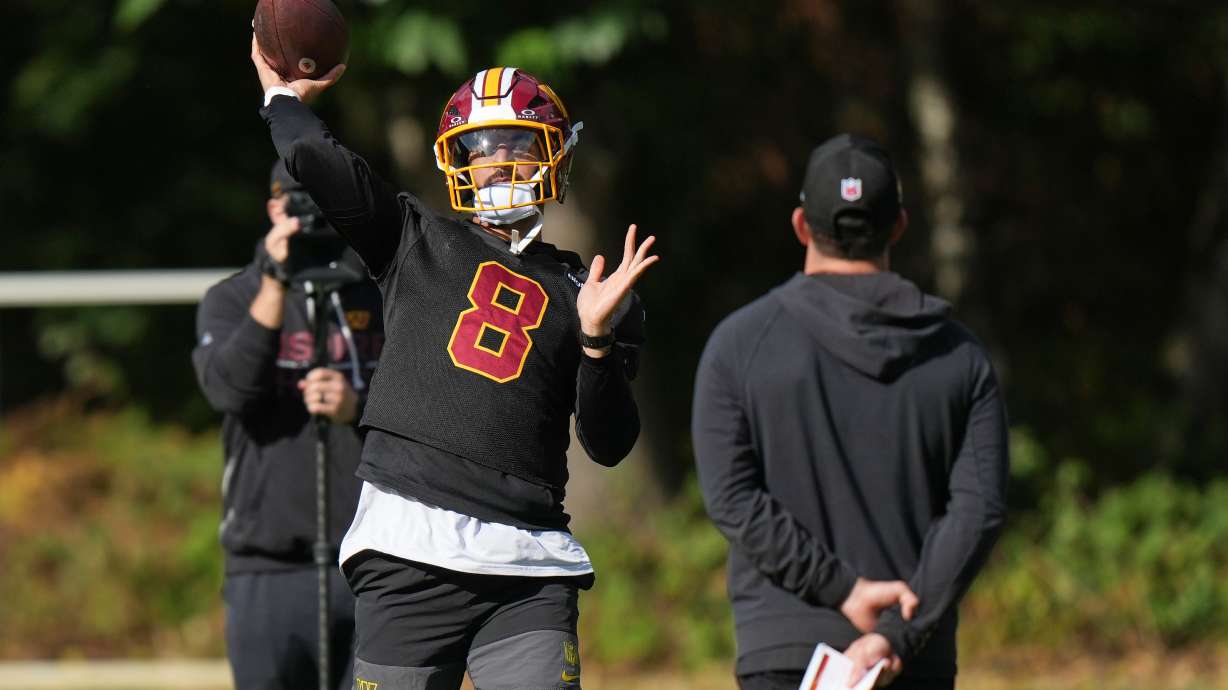 Washington Commanders' quarterback Marcus Mariota throws the ball during an NFL football practice in Hertfordshire, England, Friday, Oct. 2, 2026.