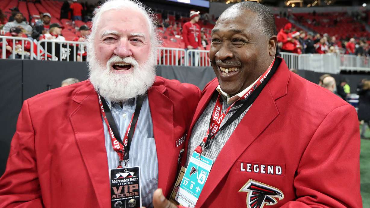 FILE - Former Atlanta Falcons center Jeff Van Note, left, and running back William Andrews smile on the sideline before the team's NFL football game against the New Orleans Saints on Dec. 7, 2017, in Atlanta.