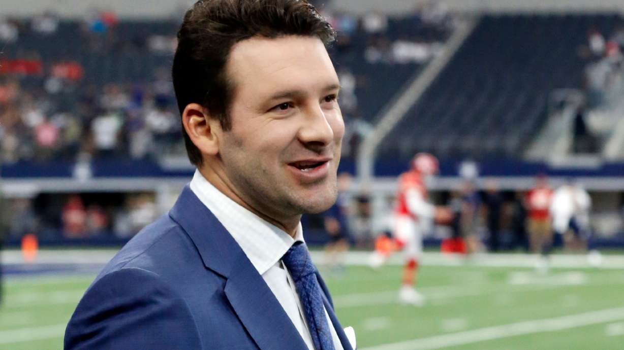 FILE - In this Nov. 5, 2017, file photo, CBS football analyst Tony Romo walks across the field during warm ups before an NFL football game between the Kansas City Chiefs and Dallas Cowboys, in Arlington, Texas.
