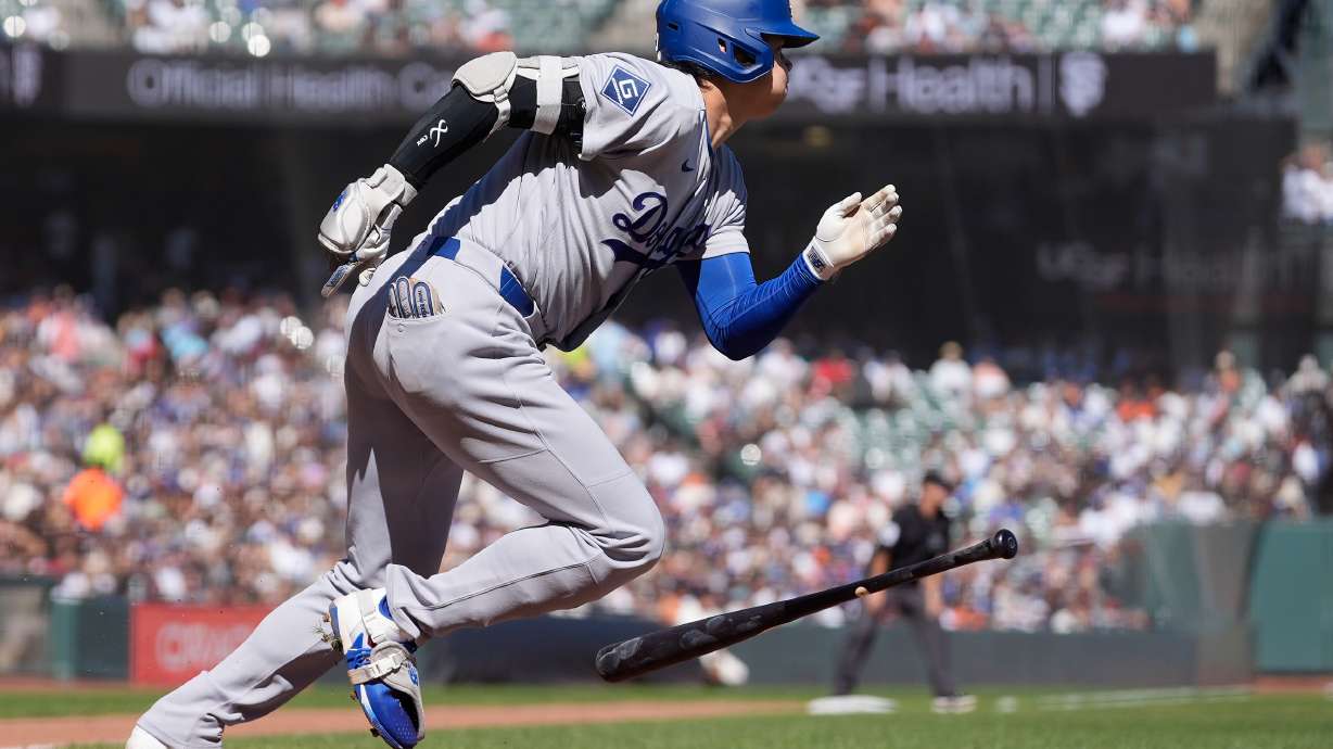 Los Angeles Dodgers designated hitter Shohei Ohtani runs to first base after hitting a single during the fifth inning of a baseball game against the San Francisco Giants, Saturday, Sept. 26, 2026, in San Francisco.