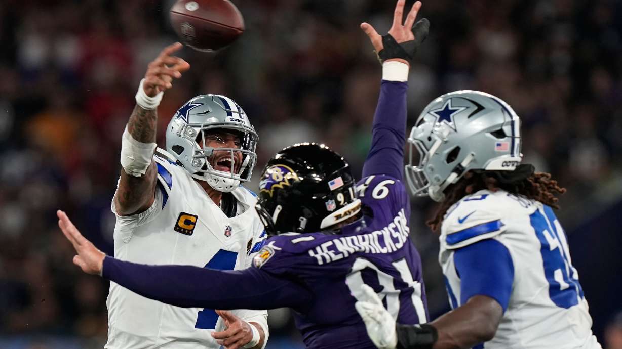 Dallas Cowboys quarterback Dak Prescott (4) throws while threatened by Baltimore Ravens linebacker Trey Hendrickson (91) during the first half of an NFL football game in Rio de Janeiro, Sunday, Sept. 27, 2026.