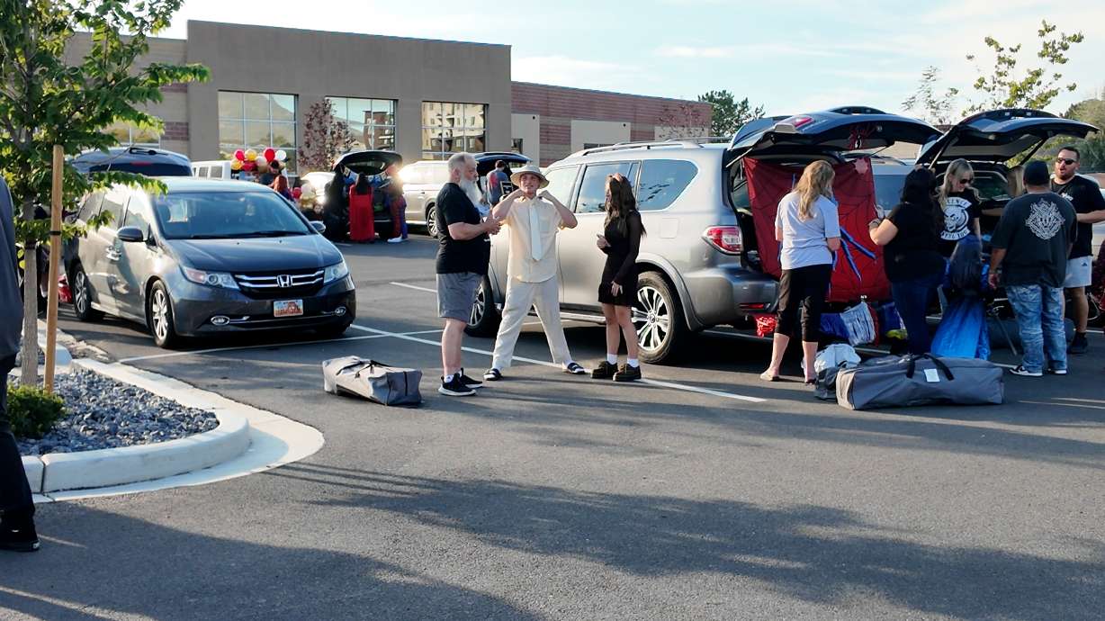 Families decorate their cars to offer Wyatt Wright an early Halloween, Friday. Dozens brought him an early Halloween in a community trunk or treat.