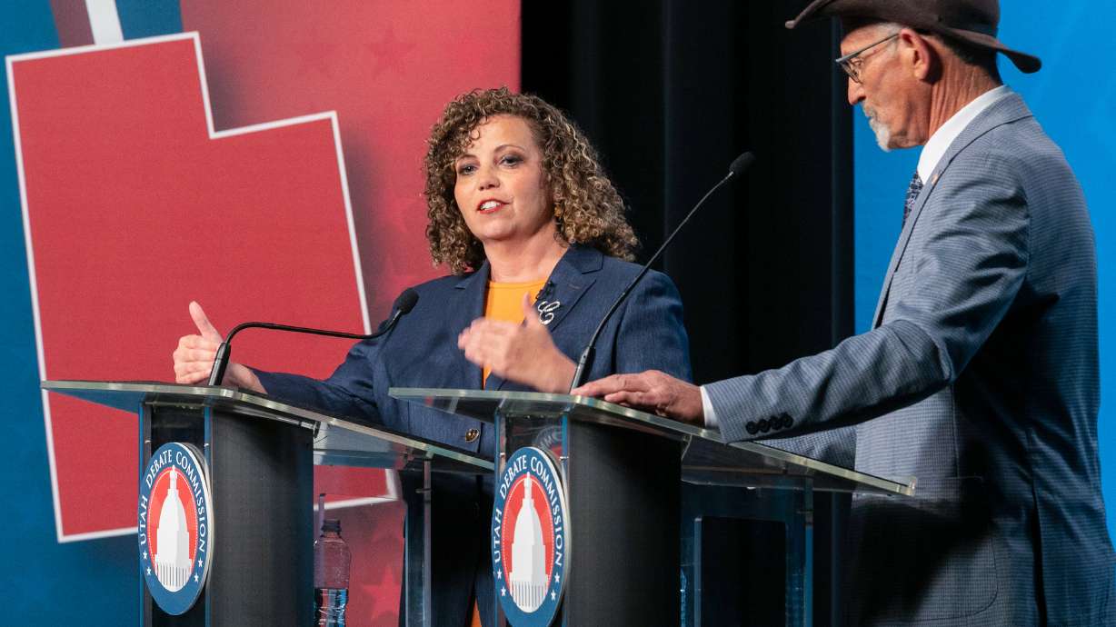 Rep. Celeste Maloy, left, listens as Kent Udell answers a question during a 3rd Congressional District debate at Utah Tech University in St. George, Friday.