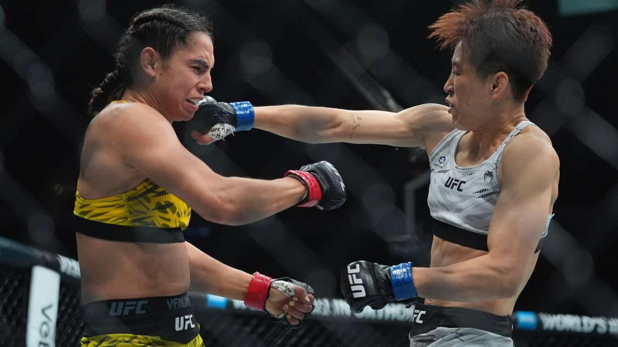 Brazil's Ariane da Silva, left, exchanges punches with China's Wang Cong during the first round of a women's flyweight bout at the UFC 316 mixed martial arts event June 7, 2025, in Newark, N.J.