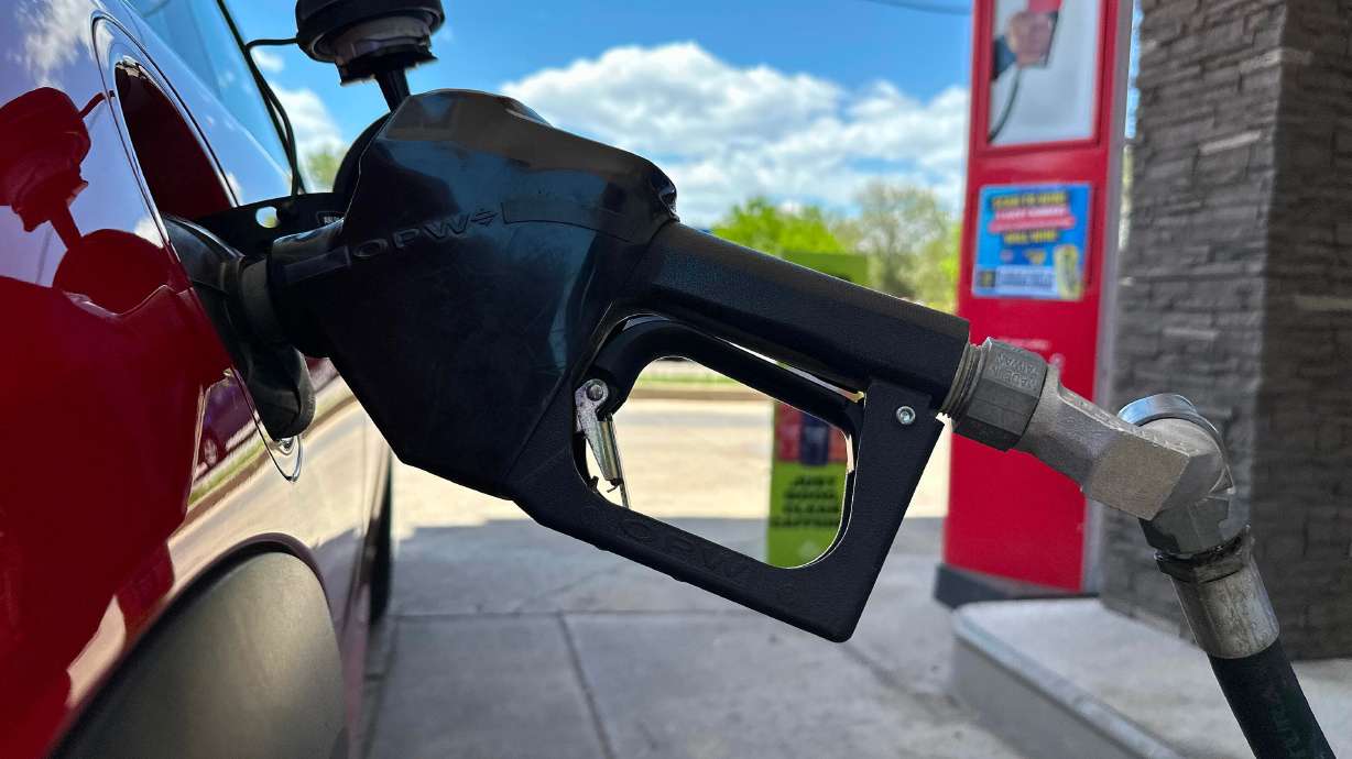 A pump fills up the tank of a vehicle at an Exxon gasoline station in Littleton, Colo., May 12.
