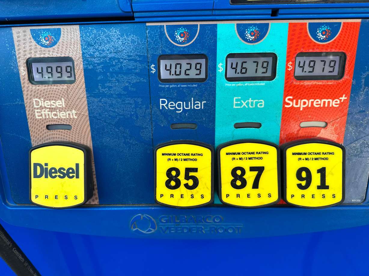 The per-gallon price is displayed electronically above the grades of gasoline available from a pump at an Exxon gasoline station in Littleton, Colo., May 12.