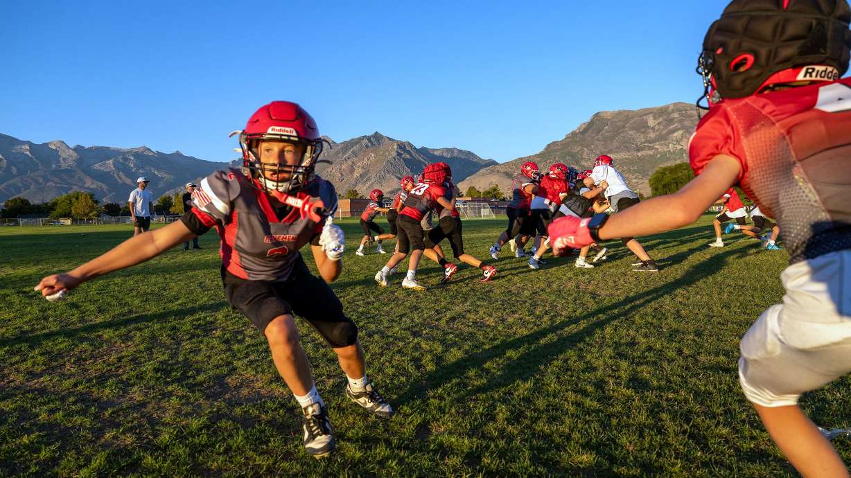 Eli Behm, takes off on a route and is defended by Brady Lark, both members of a youth football team in American Fork practice at American Fork Jr. High on Sept. 23. A majority of people nationwide are comfortable with kids playing football — to a certain extent.