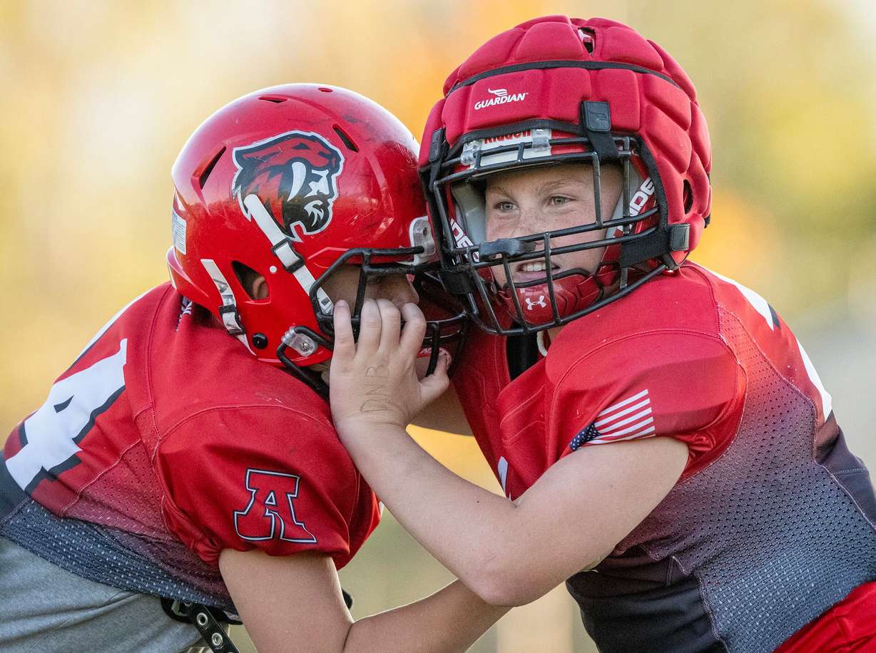 Hagan Clark battles Preston Mack during a play as members of a youth football team in American Fork go through their practice at American Fork Jr. High on on Sept. 23. A new poll showed parents are comfortable with kids playing football nationwide — to an extent.