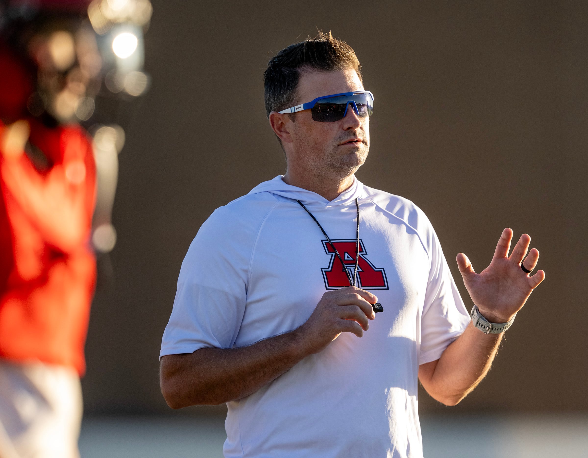 Head coach Jason Renfro talks to players as members of the American Fork youth football team go through their practice at American Fork Jr. High on Sept. 23. Renfro thinks the age of 14 is an appropriate starting age for kids to play football.