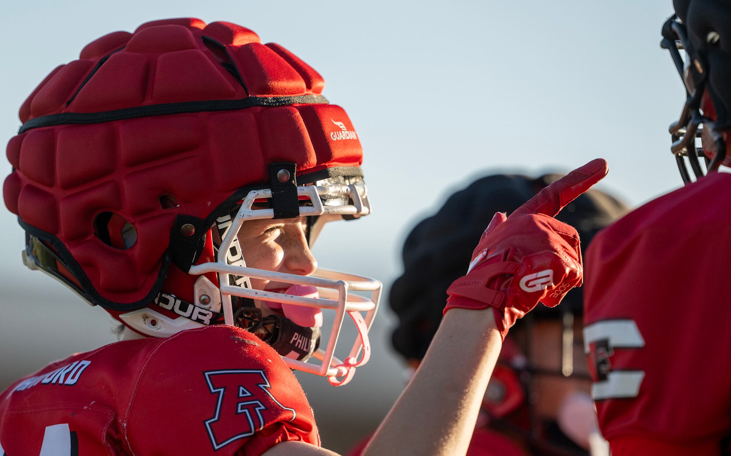 Beckham Whitford playfully points at a teammate as members of a youth football team in American Fork go through their practice at American Fork Jr. High on Sept. 23. The effectiveness of Guardian Caps has been a subject of debate.
