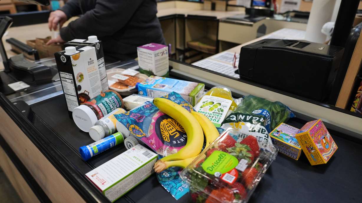 A cashier scans groceries, including produce, which is covered by the USDA Supplemental Nutrition Assistance Program, at a grocery store in Baltimore, Nov. 10. Major changes to SNAP took effect Thursday, but the biggest will be seen in the future.