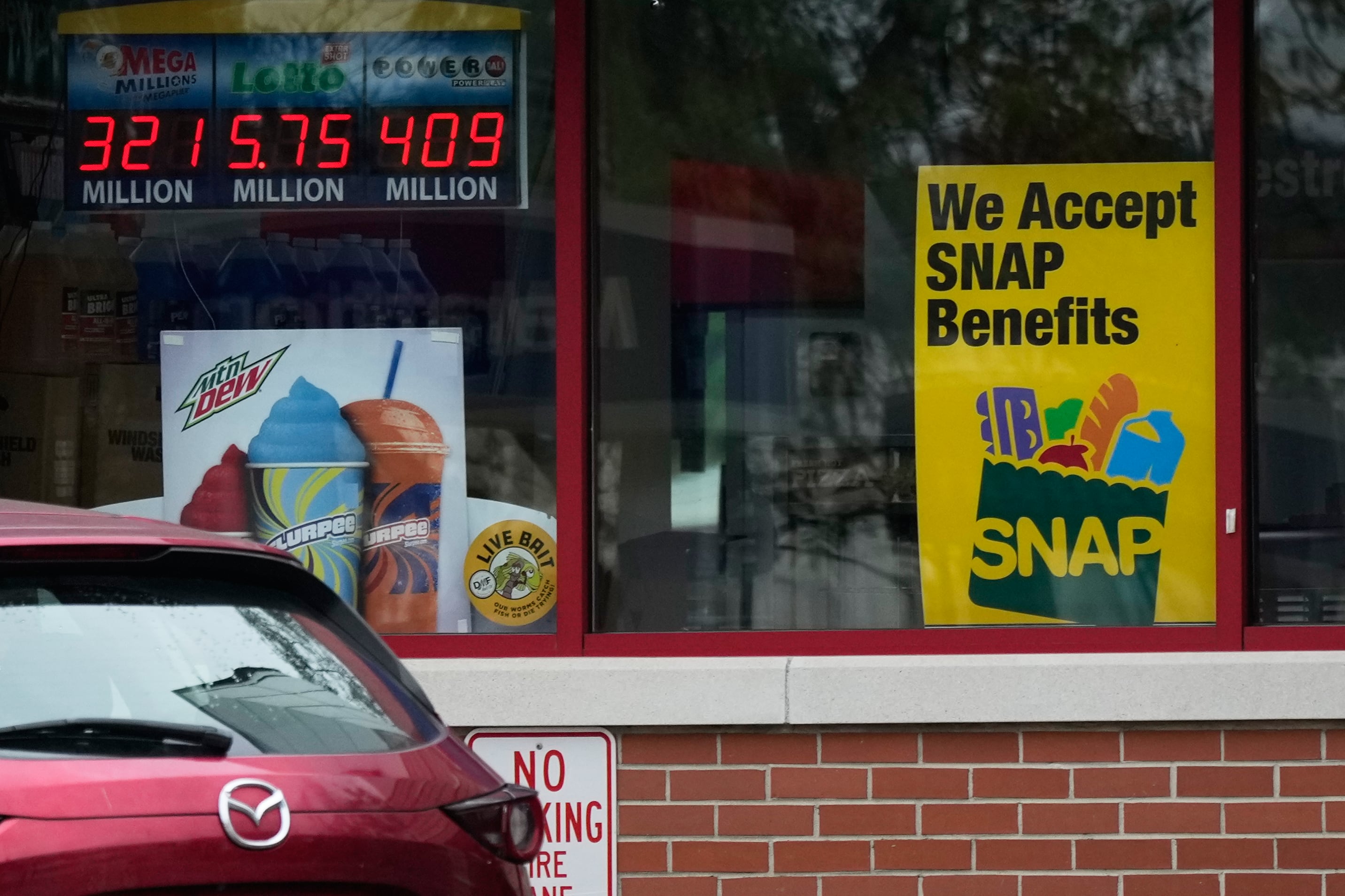 A SNAP EBT information sign is displayed at a gas station in Prospect Heights, Ill., Wednesday. SNAP benefits underwent major changes on Thursday.