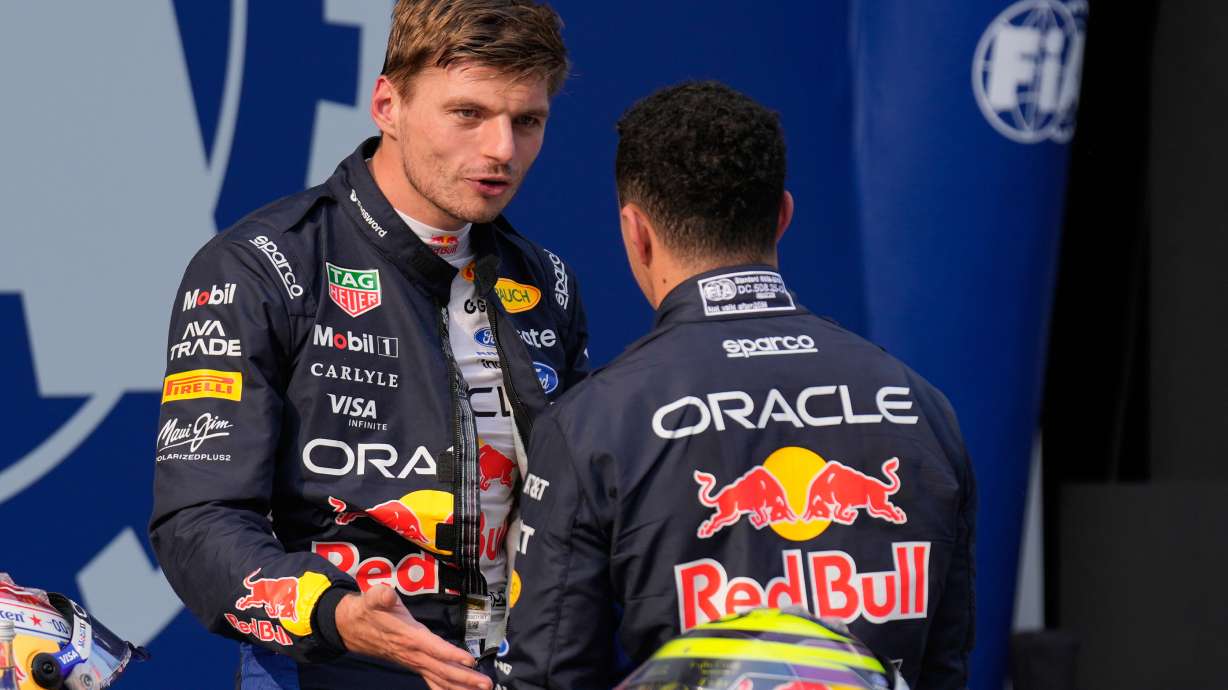 Red Bull driver Max Verstappen of the Netherlands, pole position, talks with his teammate Isack Hadjar of France, third fastest time after the qualifying session ahead of the Bahrain Grand Prix in Sepang, Malaysia, Saturday, Oct. 3, 2026.