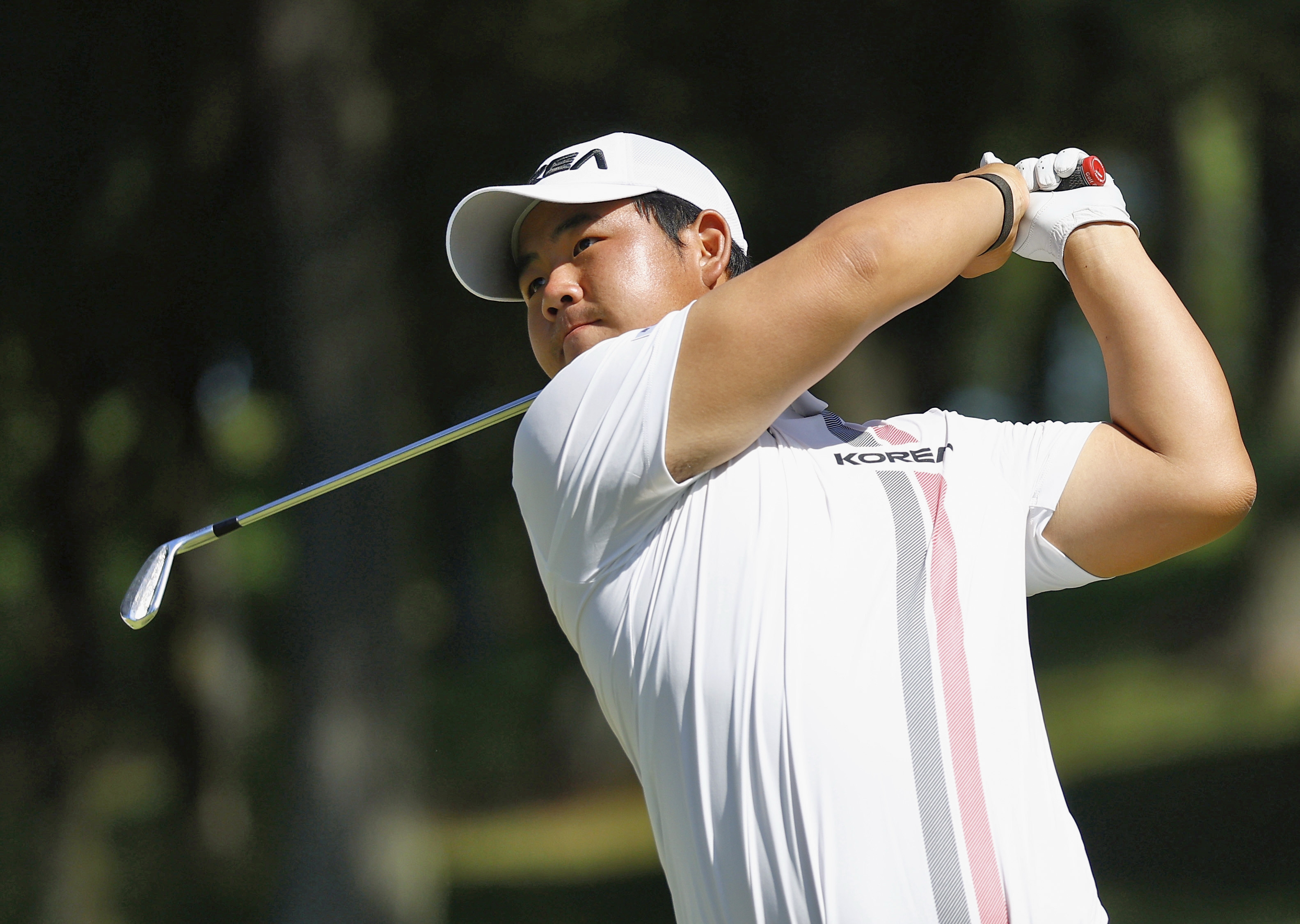 South Korea's Tom Kim, also known as Kim Joo-hyung, plays a shot in the men’s singles in golf at the Asian Games in Kasugai, central Japan, Saturday, Oct. 3, 2026. 