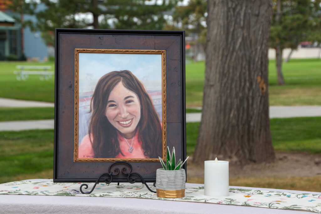 A painting of Amanda Mayne, who was murdered by her ex-husband, is displayed at a news conference announcing an online dashboard for domestic violence lethality assessment data at Veterans Memorial Park in West Jordan on Aug. 21, 2025.