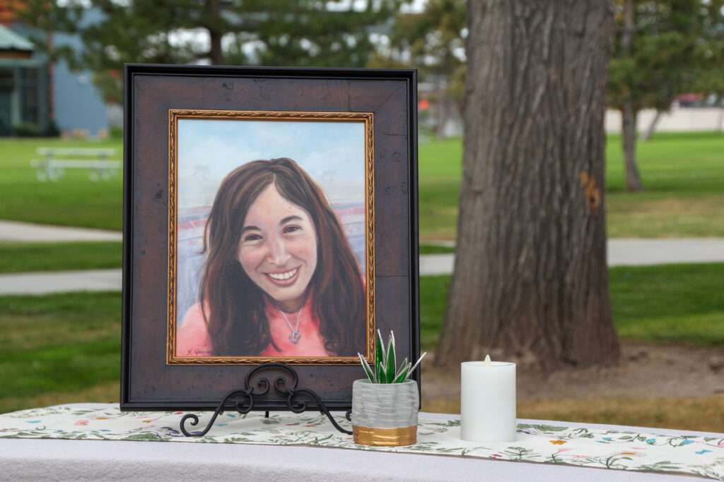 A painting of Amanda Mayne, who was murdered by her ex-husband, is displayed at a news conference announcing an online dashboard for domestic violence lethality assessment data at Veterans Memorial Park in West Jordan on Aug. 21, 2025.