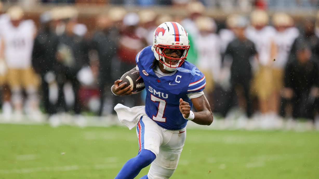 SMU quarterback Kevin Jennings rushes for a touchdown during an NCAA college football game against Boston College, Saturday, Oct. 3, 2026, in Dallas.