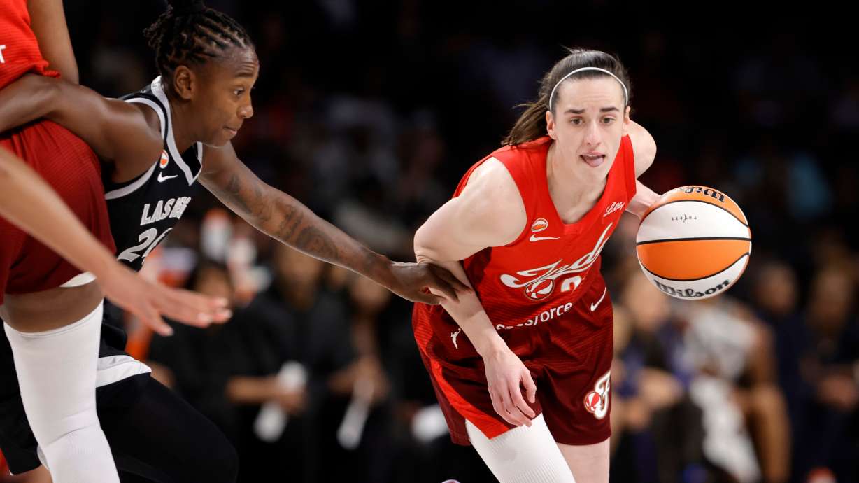 Indiana Fever guard Caitlin Clark (22) drives against Las Vegas Aces guard Jewell Loyd (24) during the first half in Game 3 of an WNBA basketball first-round playoff series Thursday, Oct.1, 2026, in Las Vegas.