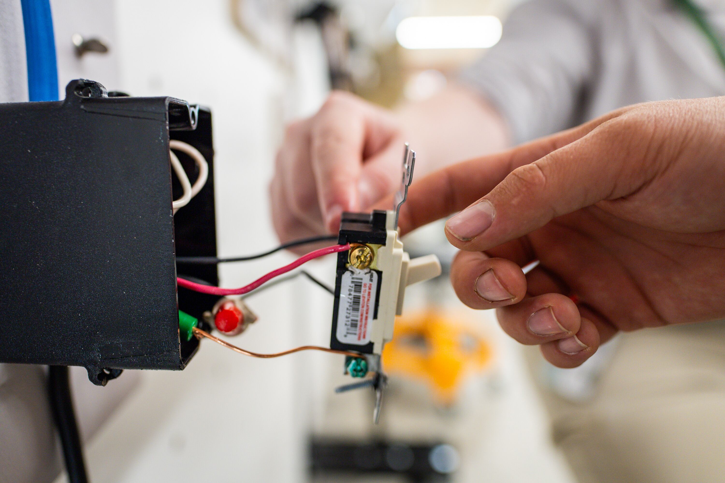 First-year students in the electrical program use the practice boards at an Ensign College open house celebrating the opening of its new electrical training program at the Vocational Technical Center  in Salt Lake City on Friday.