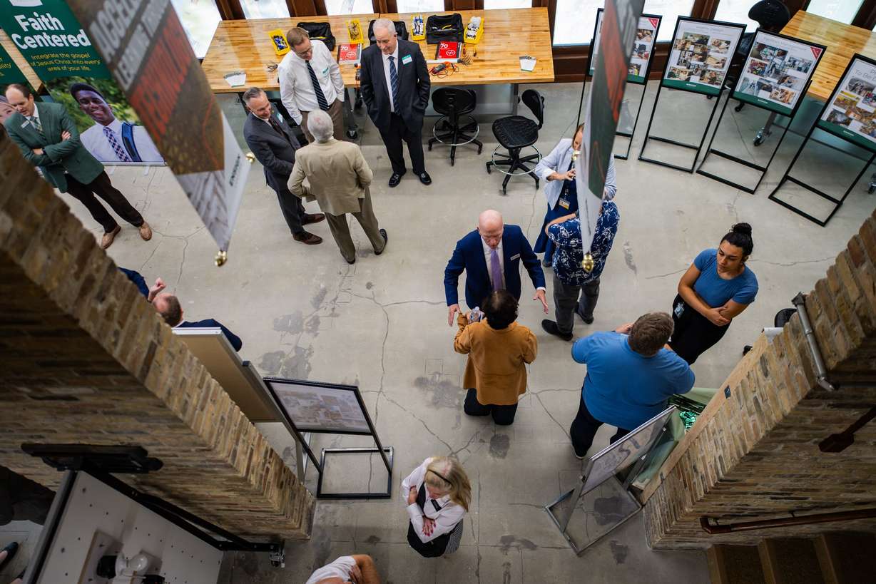 People talk at an Ensign College open house celebrating the opening of its new electrical training program at the Vocational Technical Center in Salt Lake City on Friday.