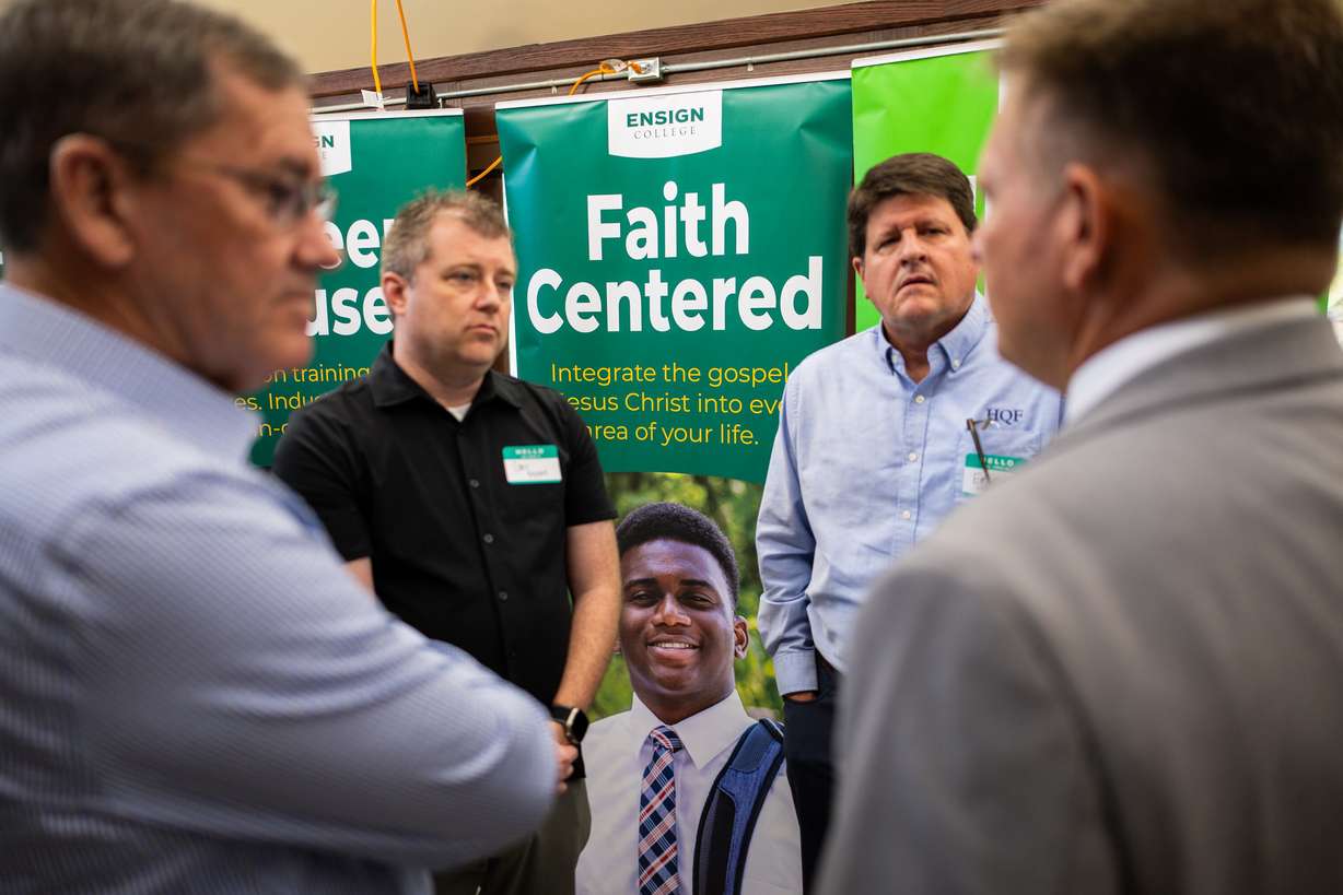 People talk at an Ensign College open house celebrating the opening of its new electrical training program at the Vocational Technical Center in Salt Lake City on Friday.