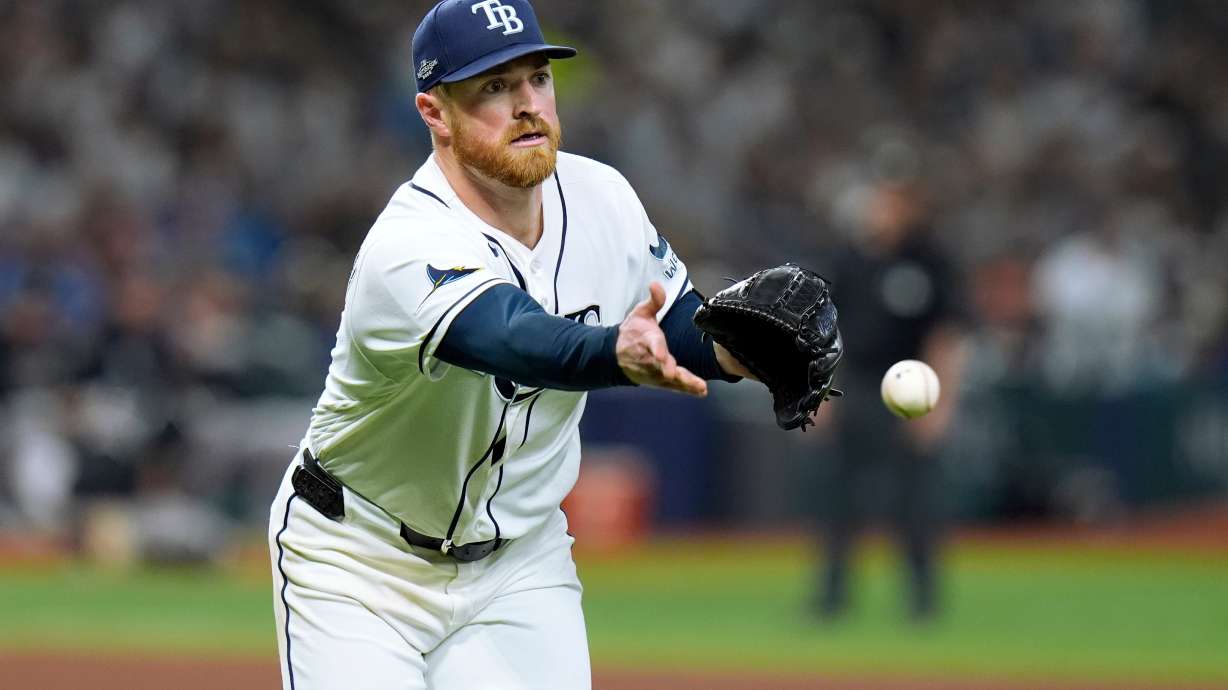 Tampa Bay Rays pitcher Drew Rasmussen tosses the ball to first base to throw out New York Yankees' Ryan McMahon on an attempted bunt during the sixth inning of Game 1 of an American League Division Series baseball game Saturday, Oct. 3, 2026, in St. Petersburg, Fla.