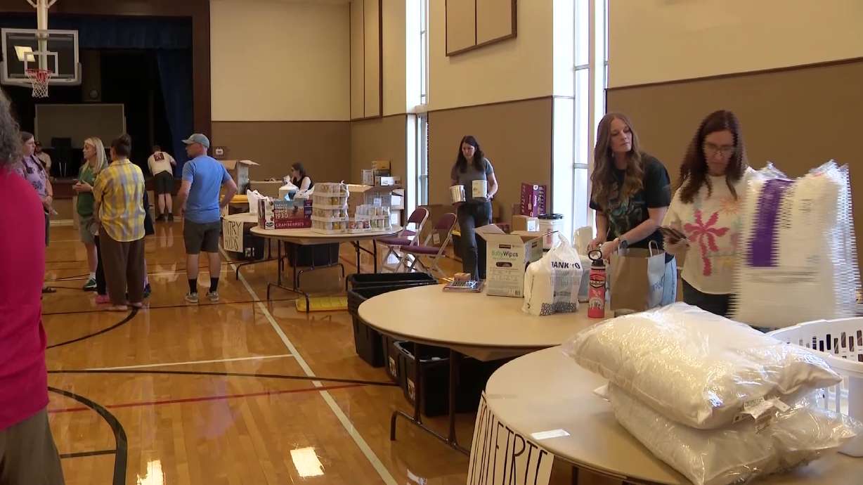 People help gather supplies during a fundraiser for the Bird family in Riverdale, Weber County, Saturday. The fundraiser will help the surviving family members recover and begin rebuilding.