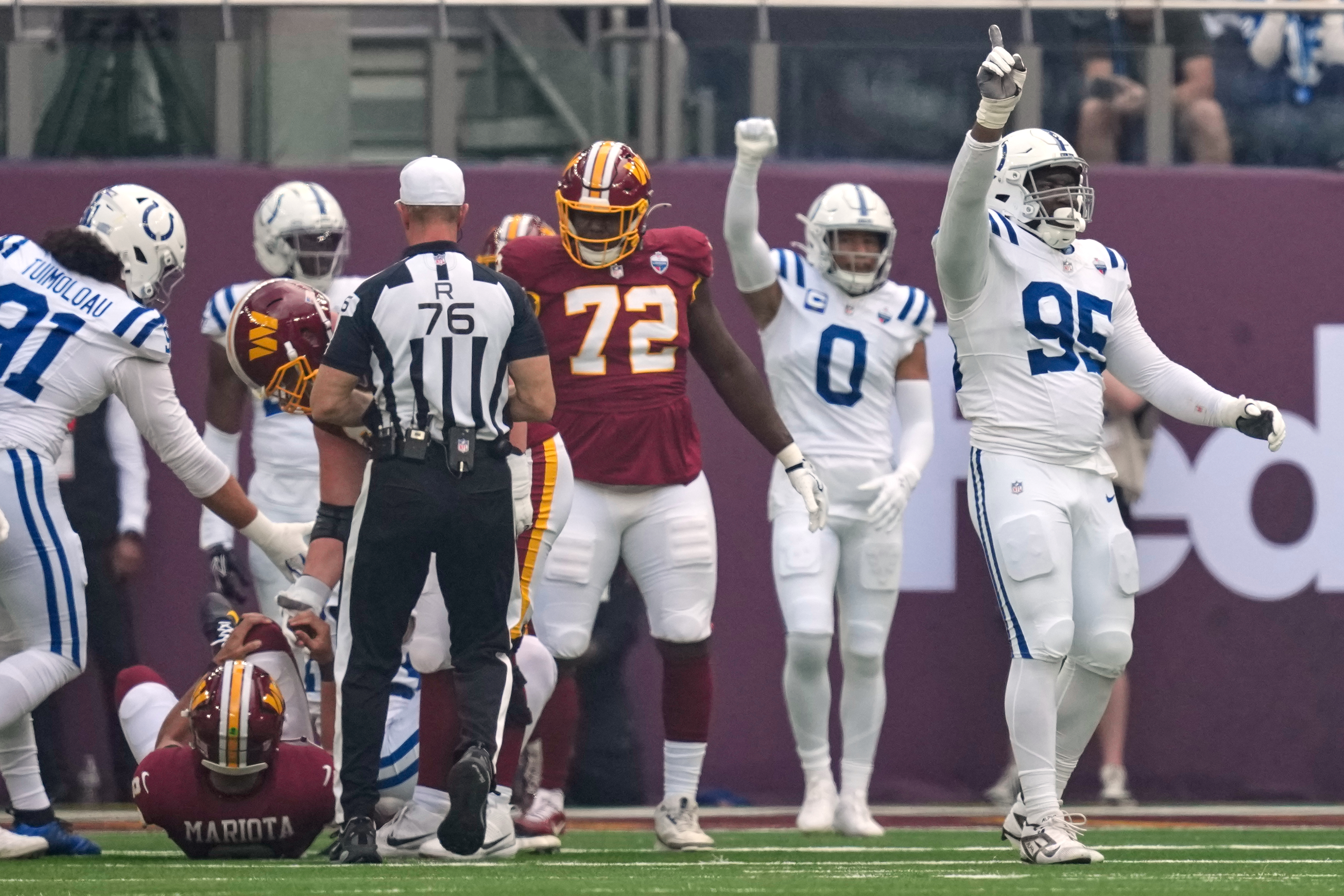 Indianapolis Colts defensive tackle Adetomiwa Adebawore (95) reacts after Washington Commanders quarterback Marcus Mariota (8), left, was sacked during an NFL football game in London, Sunday, Oct. 4, 2026. 