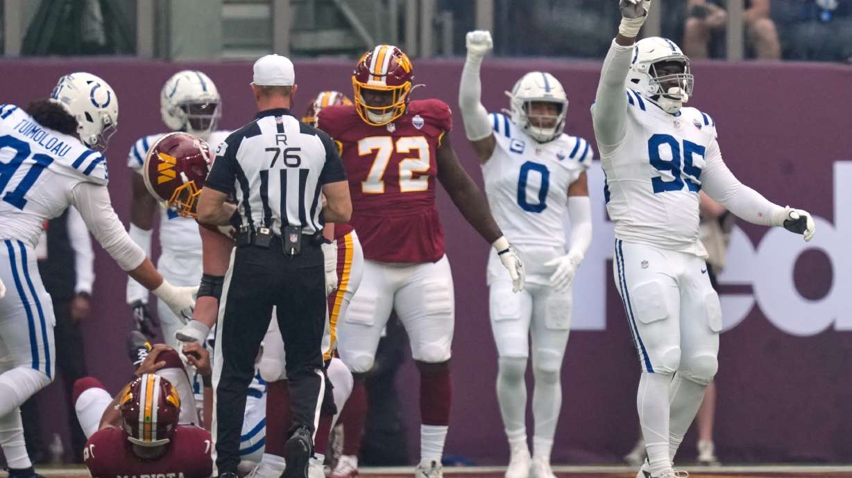 Indianapolis Colts defensive tackle Adetomiwa Adebawore (95) reacts after Washington Commanders quarterback Marcus Mariota (8), left, was sacked during an NFL football game in London, Sunday, Oct. 4, 2026.