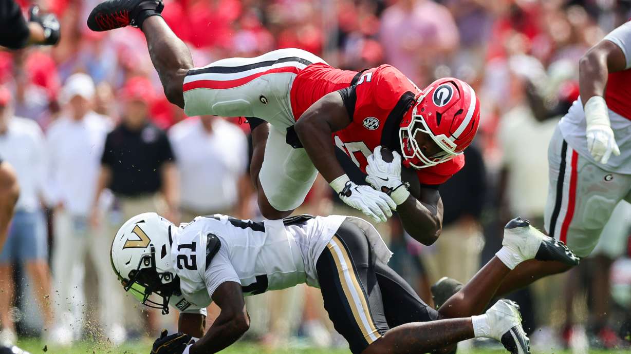Vanderbilt safety Davin Chandler (21) tackles Georgia running back Chauncey Bowens (5) during the first half of an NCAA college football game, Saturday, Oct. 3, 2026, in Athens, Ga.