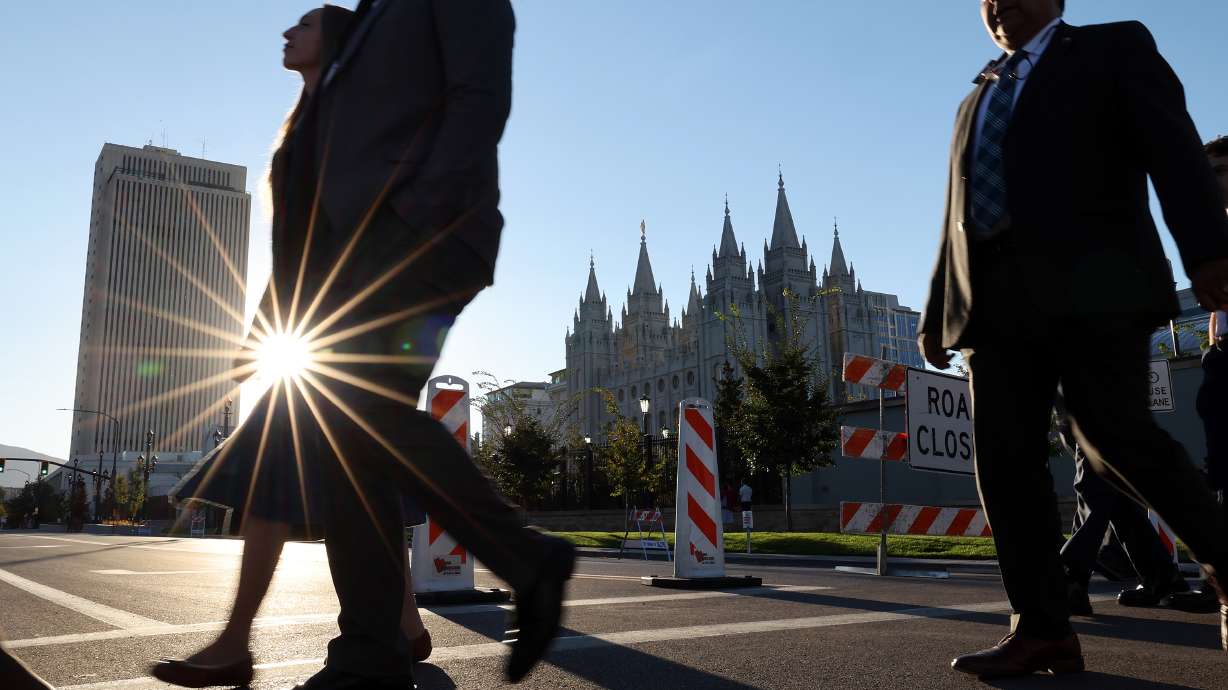 Conferencegoers make their way to the conference center for the 196th Semi-Annual General Conference of The Church of Jesus Christ of Latter-day Saints in Salt Lake City on Sunday.