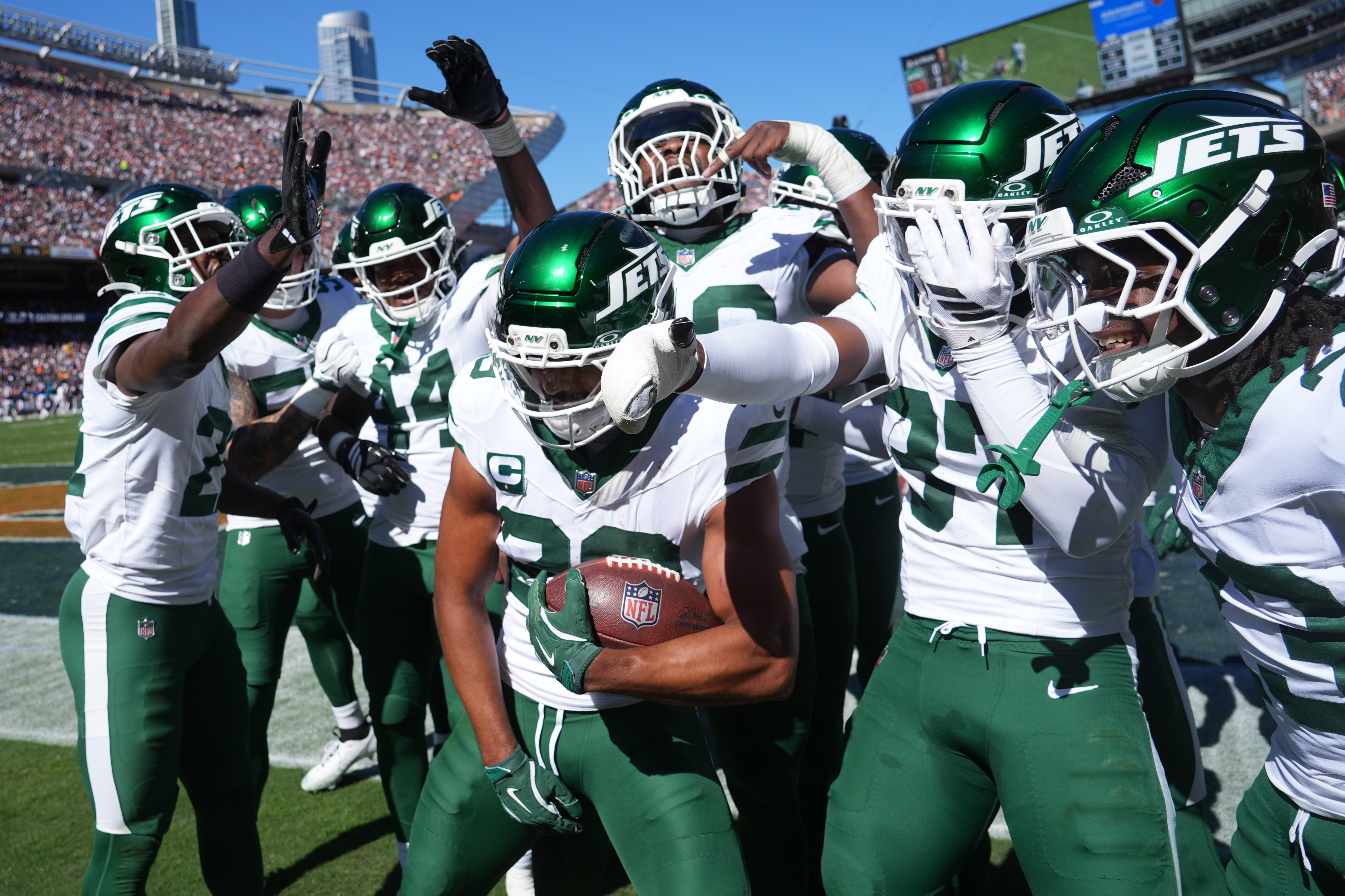New York Jets safety Minkah Fitzpatrick holds the ball as he celebrates with teammates after intercepting a pass during the first half of an NFL football game against the Chicago Bears Sunday, Oct. 4, 2026, in Chicago. 