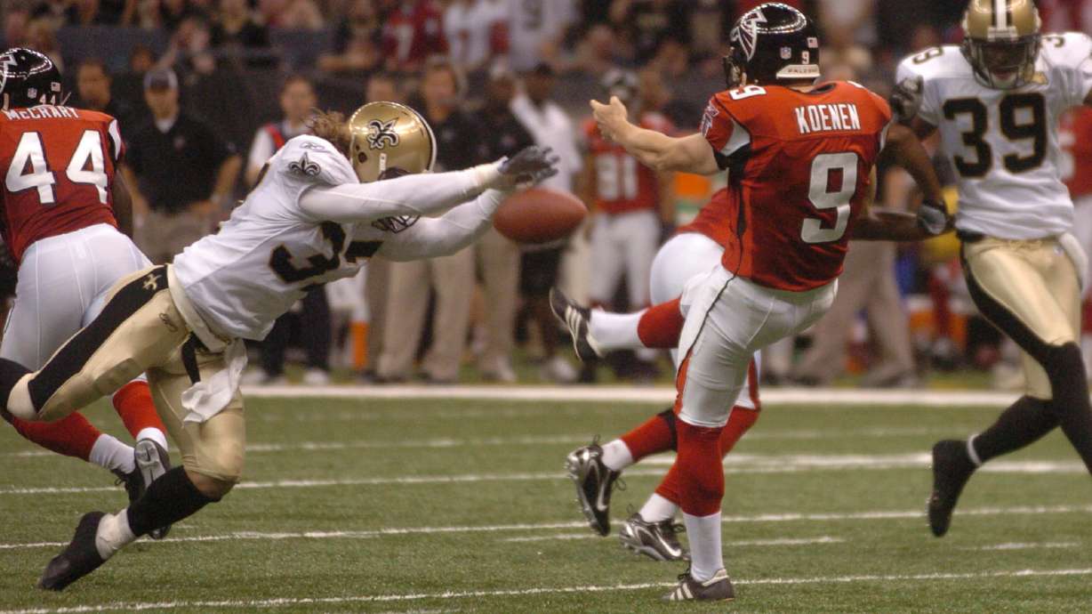 FILE - New Orleans Saints' Steve Gleason blocks a punt which the Saints ran in for the first score of an NFL football game against the Atlanta Falcons, at the Louisiana Superdome in New Orleans, Sept. 25, 2006.