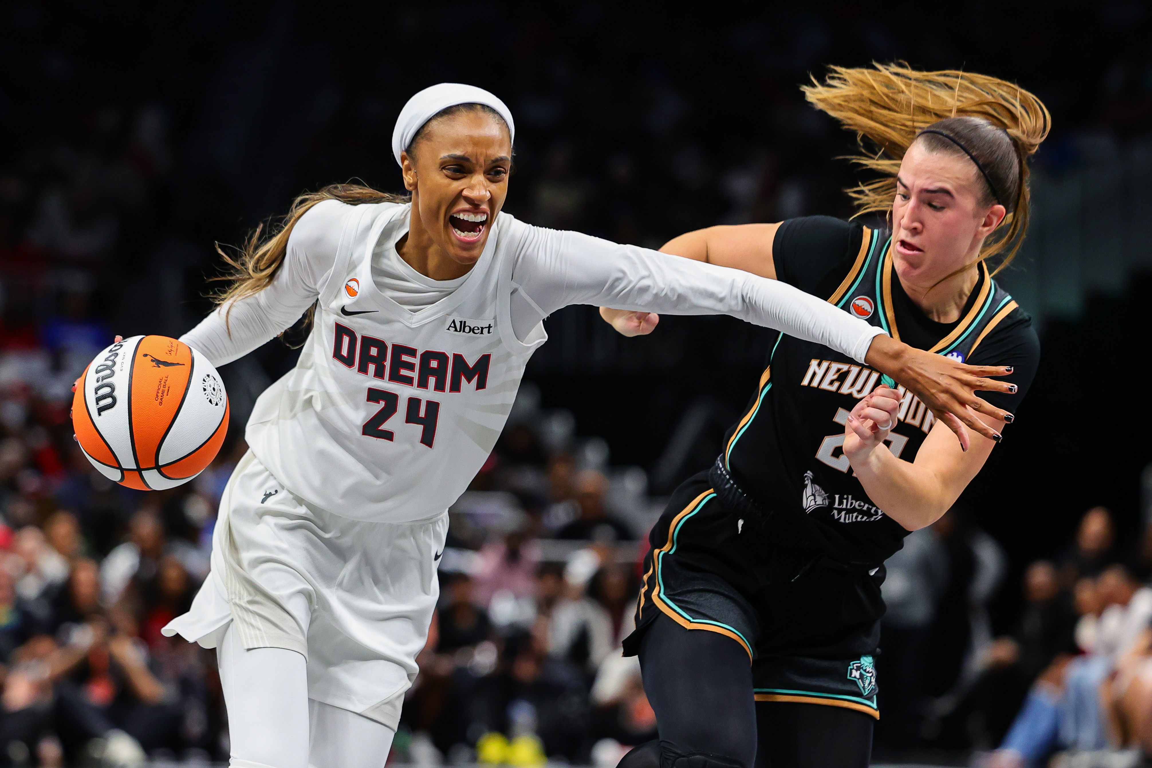 Atlanta Dream forward DeWanna Bonner (24) drives to the basket against New York Liberty guard Sabrina Ionescu, right, during the first half of Game 1 of the WNBA basketball semifinals Sunday, Oct. 4, 2026, in Atlanta. 