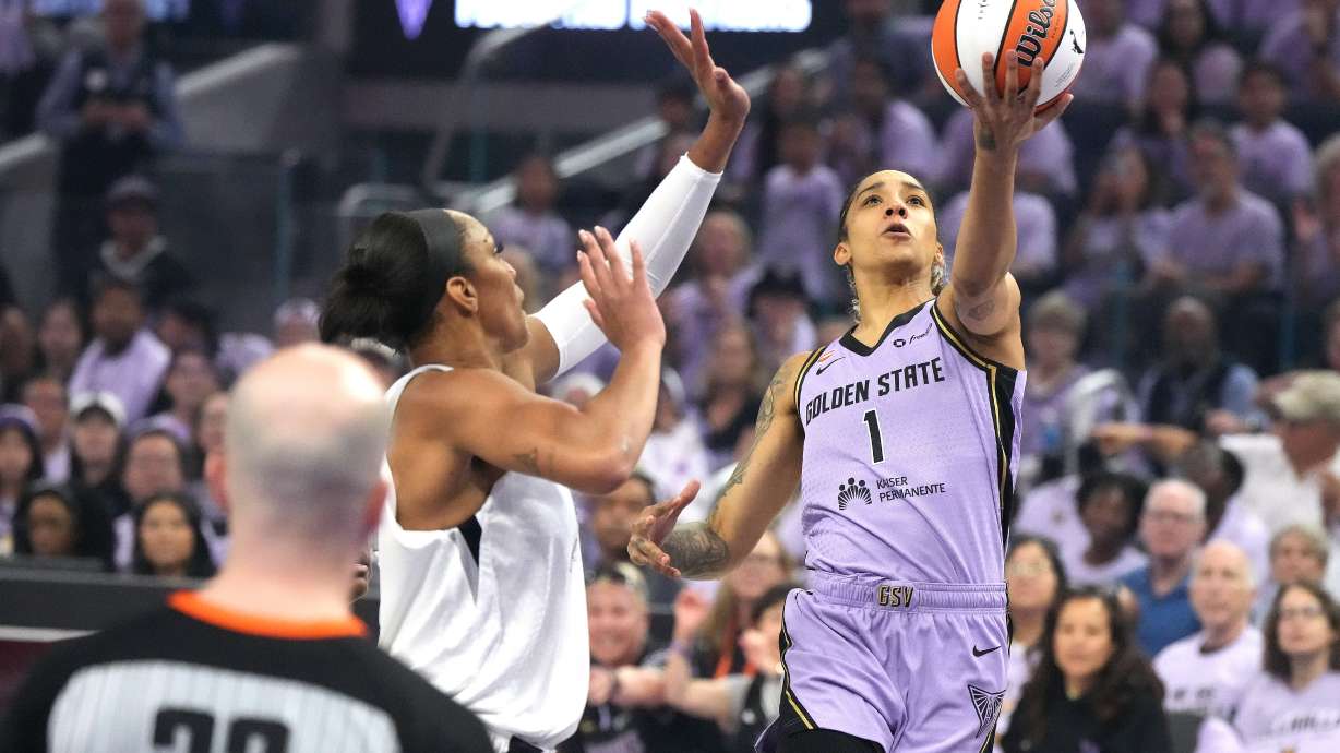 Golden State Valkyries forward Gabby Williams (1) drives to the basket against Las Vegas Aces center A'ja Wilson, second from right, during the first half of Game 1 of the WNBA basketball semifinals in San Francisco, Sunday, Oct. 4, 2026.
