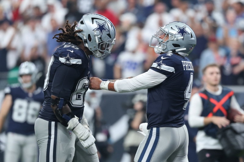 Oct 4, 2026; Houston, Texas, USA;  Dallas Cowboys quarterback Dak Prescott (4) reacts after throwing a touchdown pass against the Houston Texans during the fourth quarter at Reliant Stadium.
