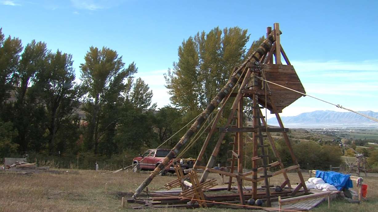 A former Utah State University student and a group of history buffs gathered at a Cache Valley farm on Saturday to launch a homemade trebuchet built using medieval techniques.