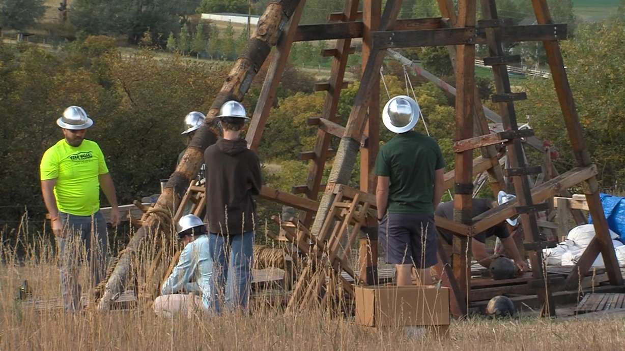 A former Utah State University student and a group of history buffs gathered at a Cache Valley farm on Saturday to launch a homemade trebuchet built using medieval techniques.