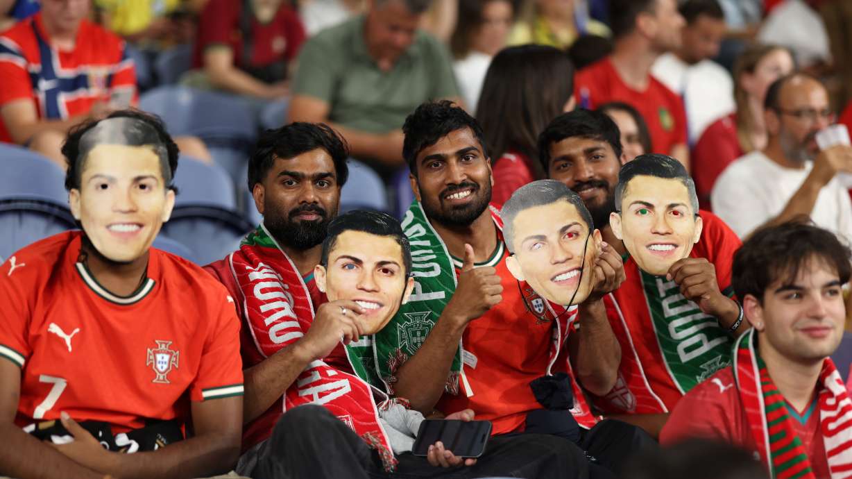 Fans on the stands holds masks of Portugal's Cristiano Ronaldo during the Nations League soccer match between Portugal and Norway in Porto, Portugal, Sunday, Oct. 4, 2026.
